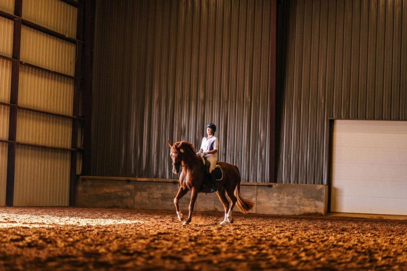Woman Riding Dressage in Warm Up Arena